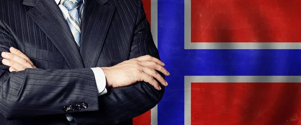 Crossed hands against Norwegian flag background, business, politics and education in Norway concept