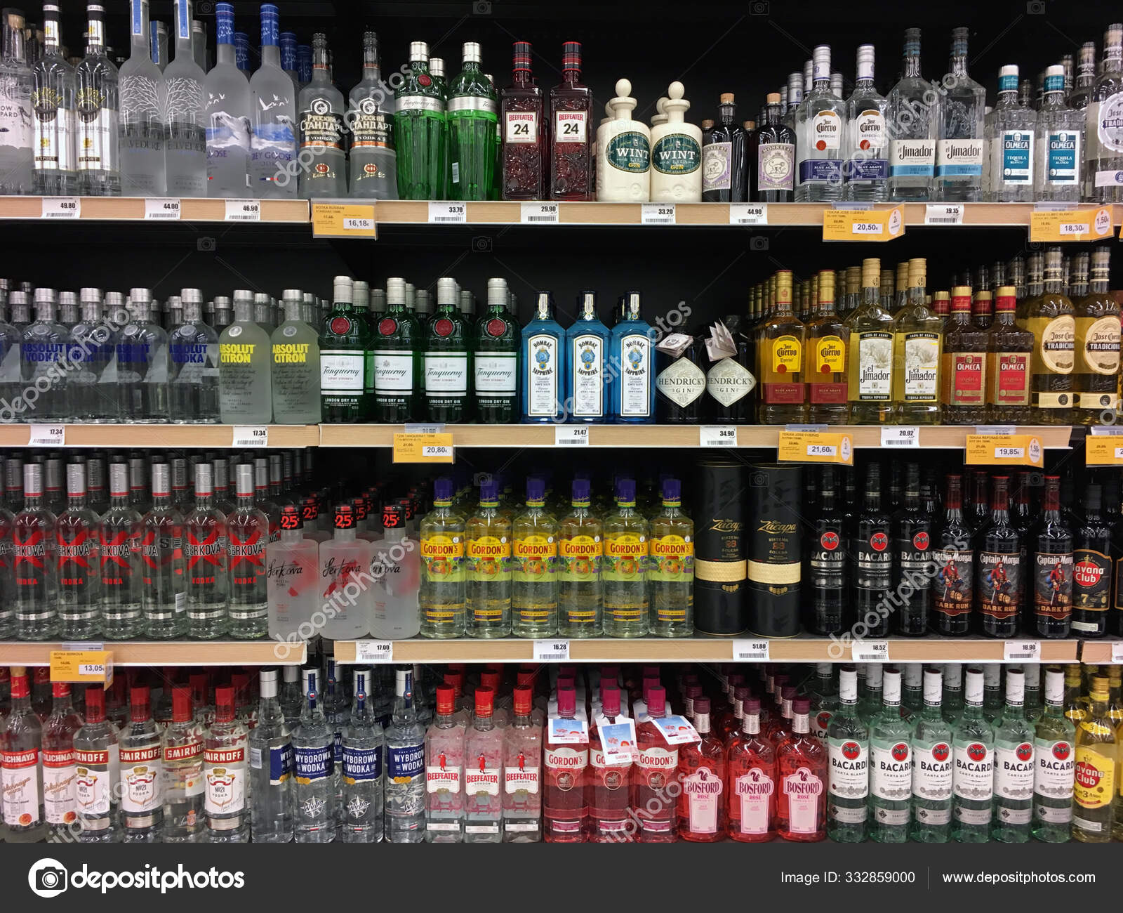 Vodka gin tequila and rum bottles on liquor store shelves Stock