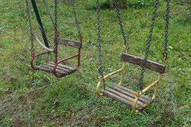 wooden swings in disused playground