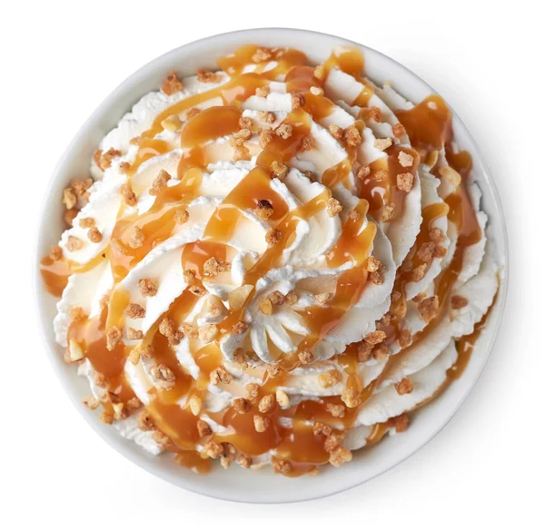 Bowl of whipped cream decorated with caramel sauce and nuts — Stock Photo, Image