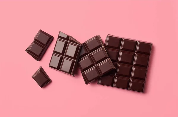 Dark chocolate on pink background — Stock Photo, Image