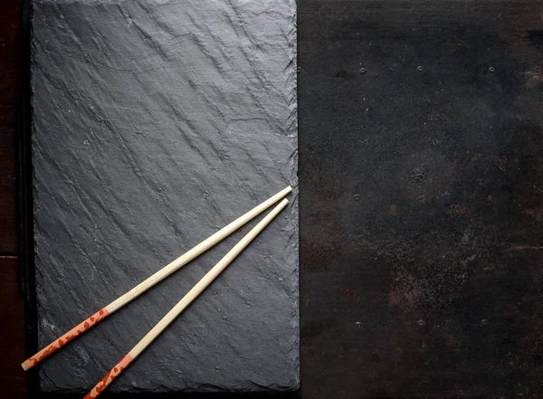 Sushi black slate and chopsticks — Stock Photo, Image