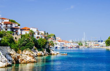 Old town view of Skiathos island, Sporades, Greece. Greek traditional architecture and aegean sea. Popular summer holiday destination scene. clipart