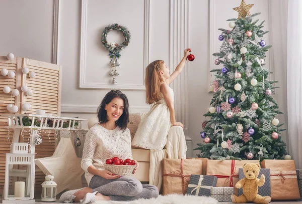 Μαμά και κόρη στολίζουν το χριστουγεννιάτικο δέντρο.. — Φωτογραφία Αρχείου