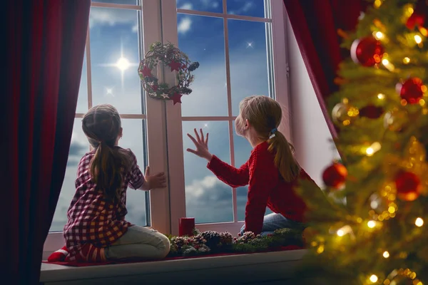 Girls sitting by window — Stock Photo, Image