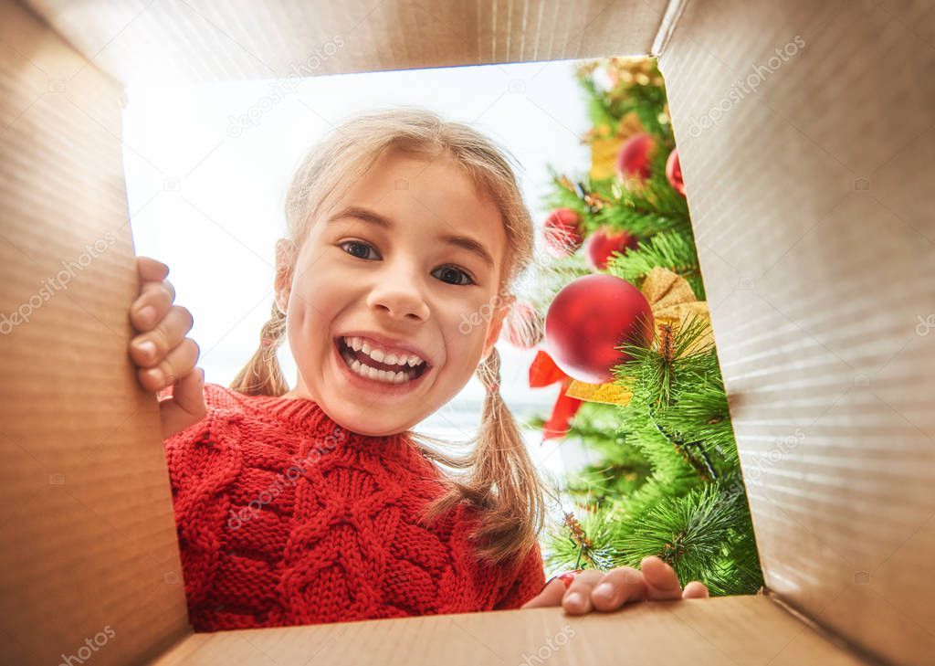 girl opening a Christmas present