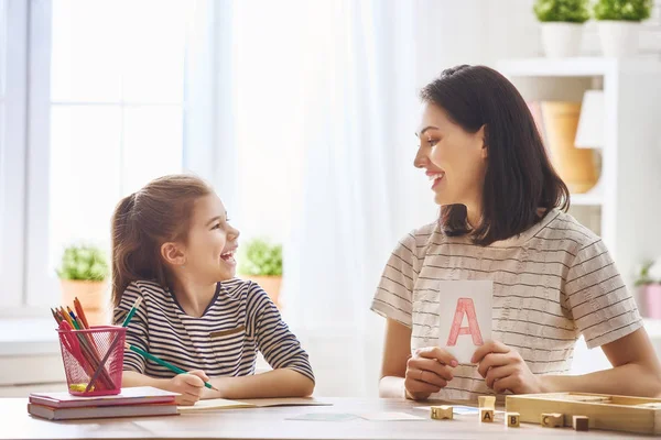 Woman teaches child the alphabet — Stock Photo, Image