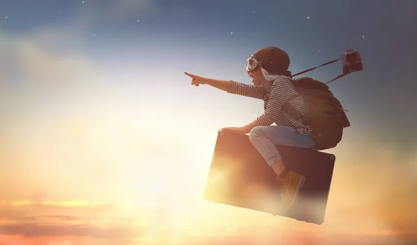 Child flying on a suitcase — Stock Photo, Image