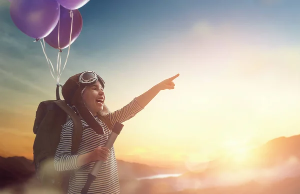 Child flying on balloons — Stock Photo, Image