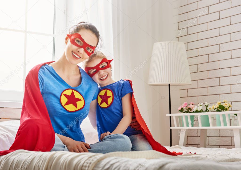 Girl and mom in Superhero costumes