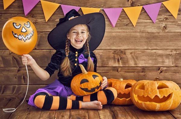Little witch with a pumpkin — Stock Photo, Image