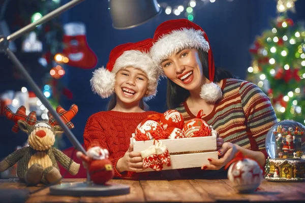 Mom and daughter near the Christmas tree — Stock Photo, Image