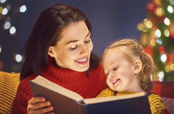 Mother reading a book at Christmas — Stock Photo, Image