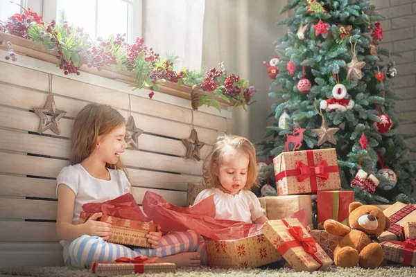 Girls opening gifts — Stock Photo, Image