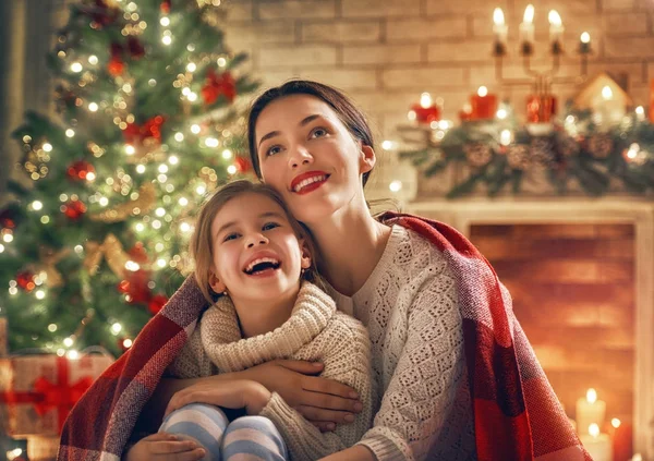 Premium Photo  Merry christmas and happy holidays! cheerful grandma and  her cute grand daughter girl exchanging gifts. granny and little child  having fun near tree indoors. loving family with presents in