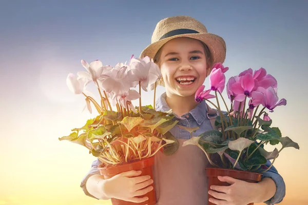 Menina com flores em vasos — Fotografia de Stock