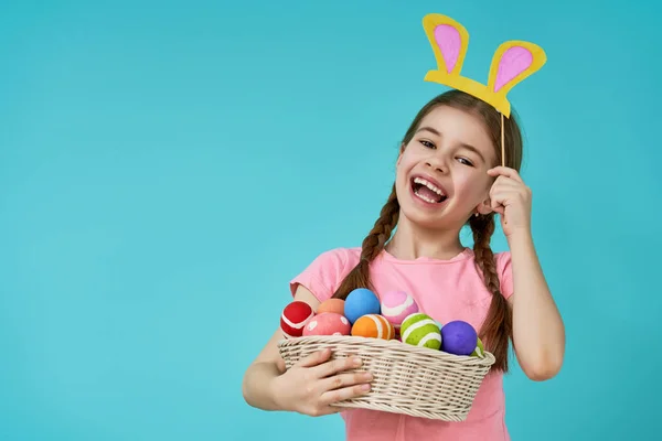 Girl holding basket with painted eggs — Stock Photo, Image