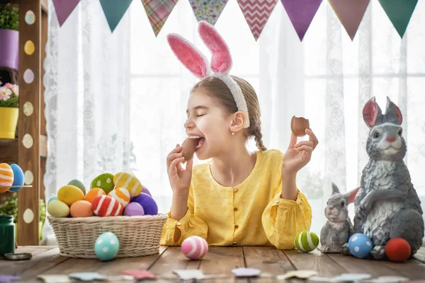 Child is eating chocolate eggs — Stock Photo, Image