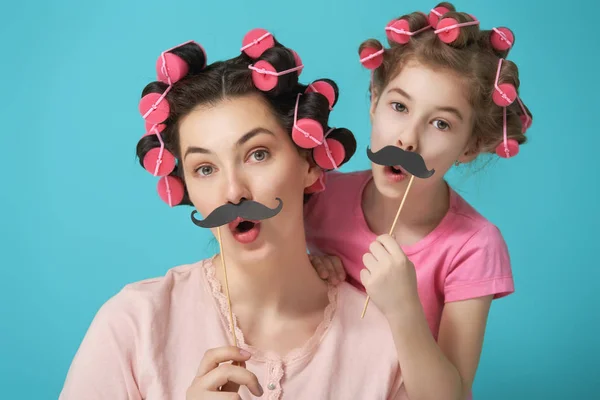 Mother and her daughter with a paper accessories — Stock Photo, Image