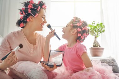 Mom and child doing makeup clipart