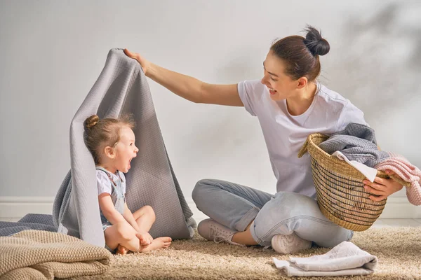 Family doing laundry at home — Stock Photo, Image