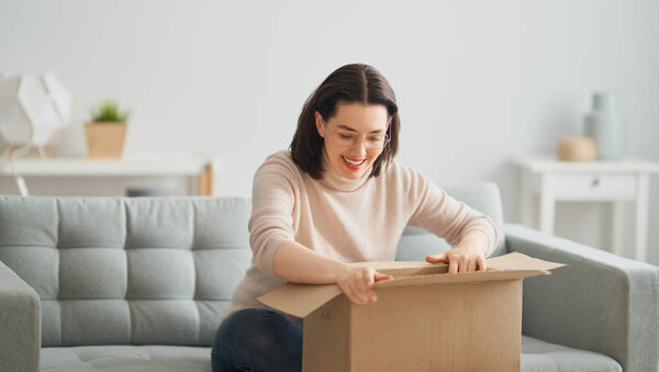 woman is holding cardboard box