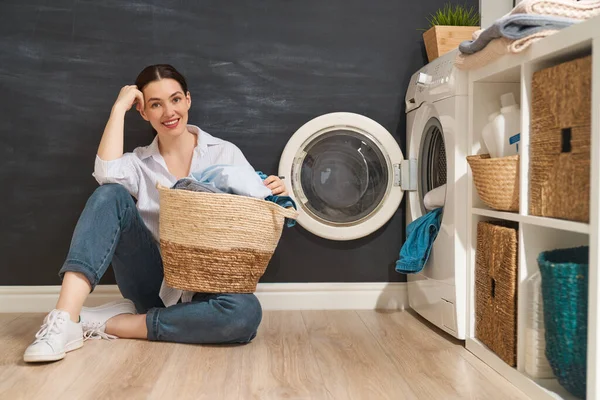 Hermosa Joven Mujer Sonríe Mientras Hace Colada Casa — Foto de Stock