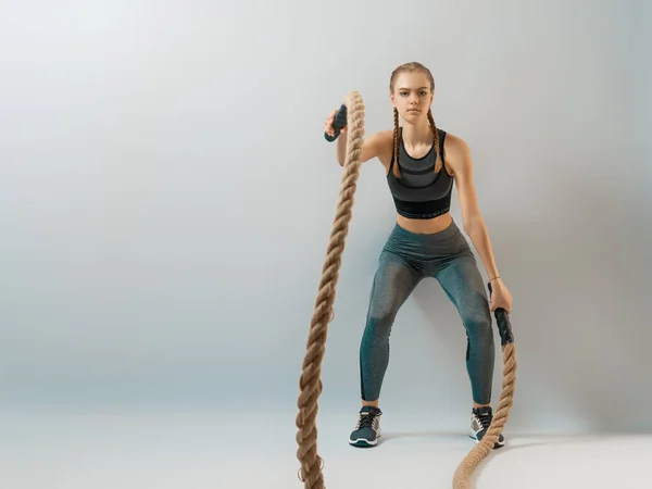 Athletic Young Woman Doing Crossfit Exercises Rope Grey Background — 스톡 사진