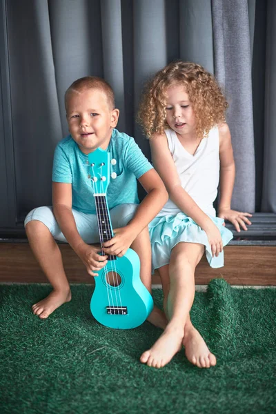 Portrait of a cute kids with ukulele — Stock Photo, Image
