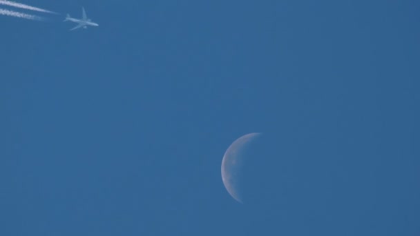 Airliner flying high and moon — Stock Video
