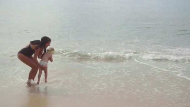 Mamma con una figlia di due anni che cammina lungo la spiaggia di sabbia — Video Stock