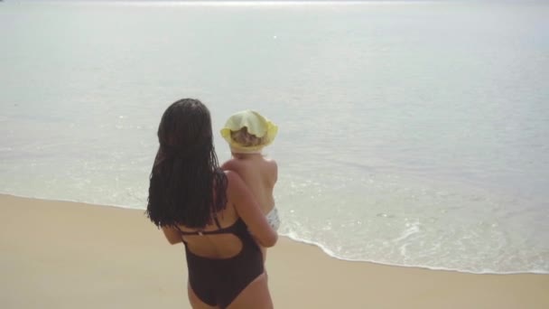 Anyu sétált a tengerparton, egy kettő-év-régi lányával — Stock videók