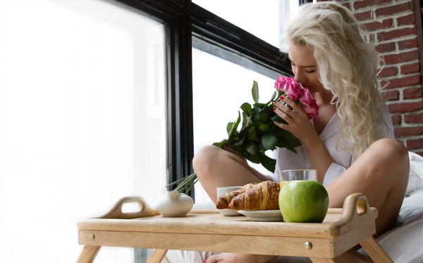 Vacker kvinna har blommor på frukost — Stockfoto