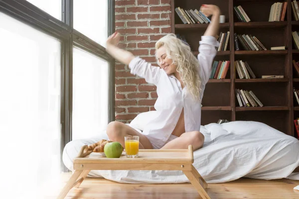 Schöne Frau dehnt sich im Bett — Stockfoto