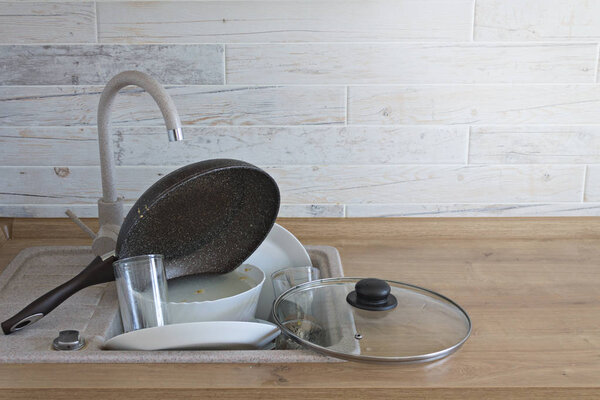 A lot of Dirty Ware in the Kitchen Sink.