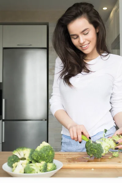 Beautiful Girl Preparing Broccoli. Losing weight. Nutrition