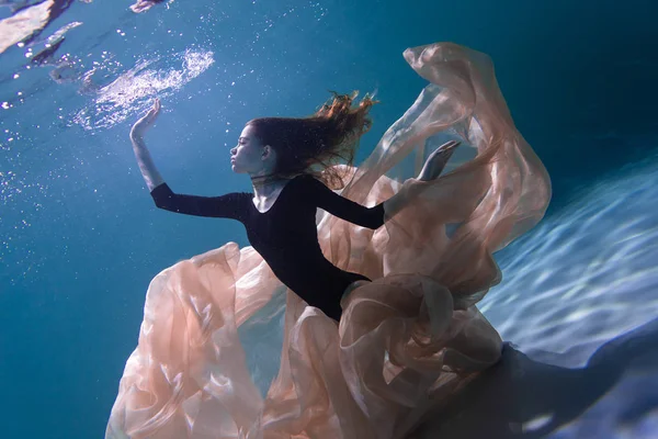 Young Slender Girl Underwater with a Cloth. Water Magic. Underwater Photography. Art