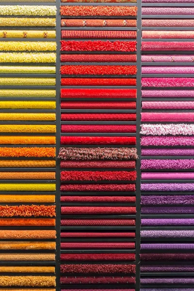 Multicolored carpets samples  on showcase — Stock Photo, Image