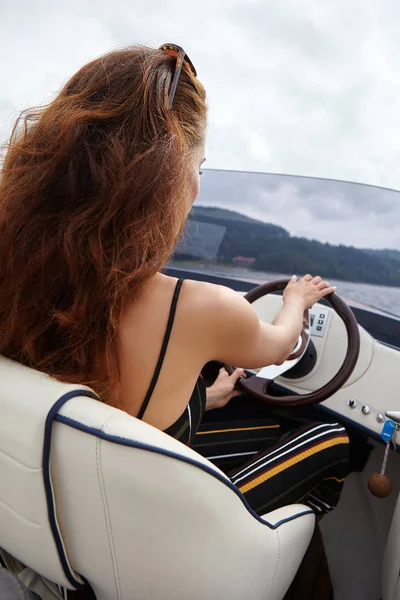 Young girl driving a motor boat — Stock Photo, Image