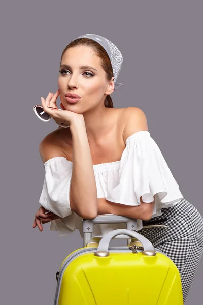 Glamour woman with yellow suitcase — Stock Photo, Image