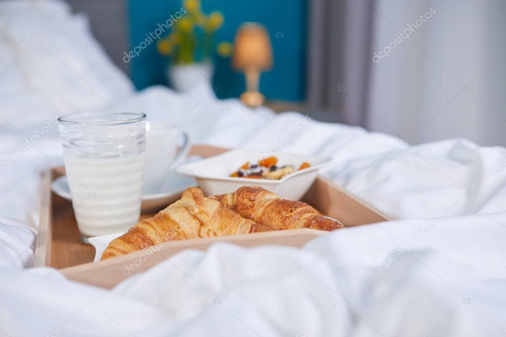 breakfast in bed with coffee and croissants