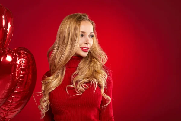 Красива блондинка позує на червоному — стокове фото