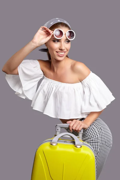 Glamour woman with yellow suitcase — Stock Photo, Image