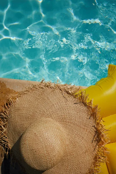 Hat on a yellow air mattress — Stock Photo, Image