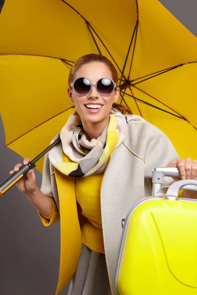 Glamour woman with yellow suitcase — Stock Photo, Image