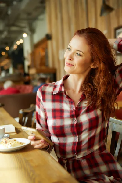 Beautiful red-haired woman in cafe. Blogger work concept — Stock Photo, Image