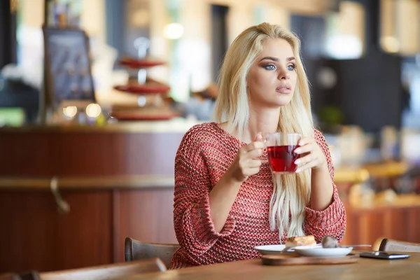 Jonge modieuze vrouw drinkt thee — Stockfoto