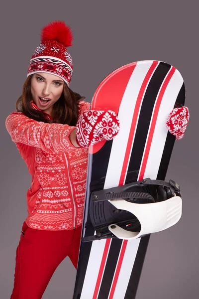 Woman holding a snowboard in studio — Stock Photo, Image