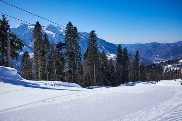 Skiers on the chairlift - ski resort during winter sunny day — Stock Photo, Image