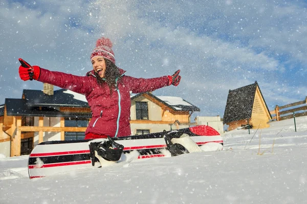 Sport woman  snowboarder on snow over winter resort